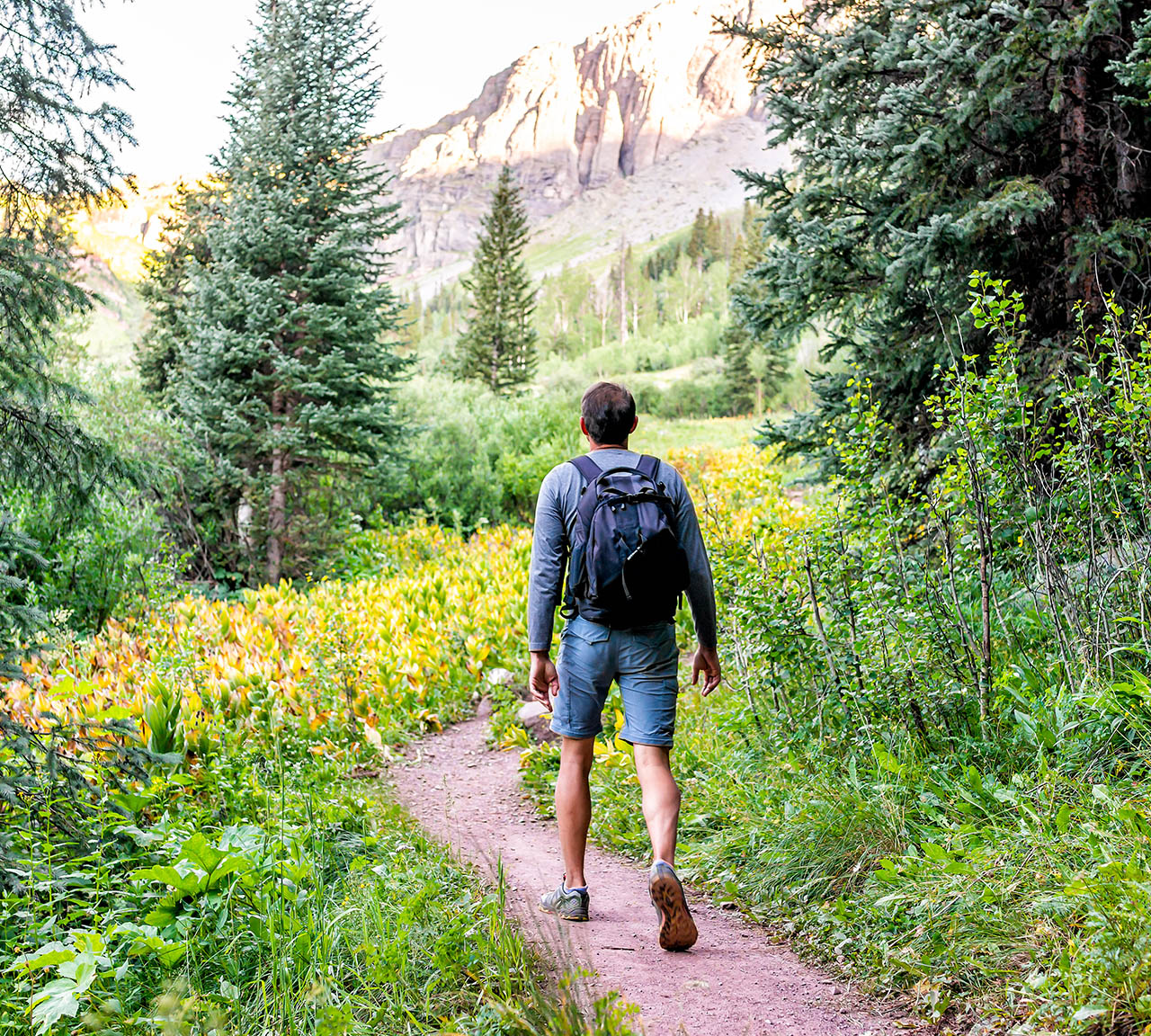 A man enjoying a hike through the beautiful Grand Targhee Resort grounds on the western side of the Tetons